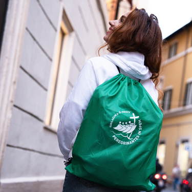 A person carrying the Jubilee 2025 RPET Knapsack